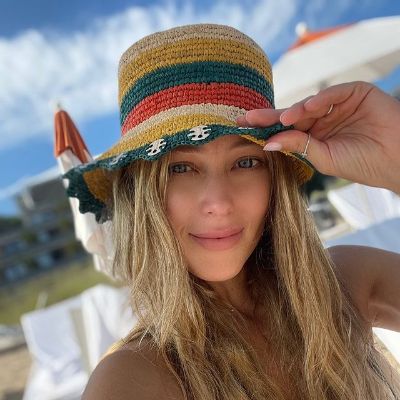 She is wearing a colorful hat in the selfie.